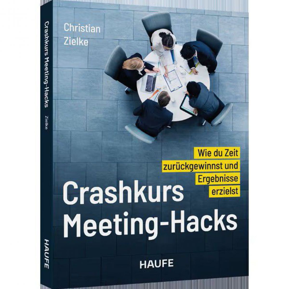 Das Cover zeigt 5 Personen, die um einen runden Tisch sitzen und ein Meeting haben, von oben fotografiert.