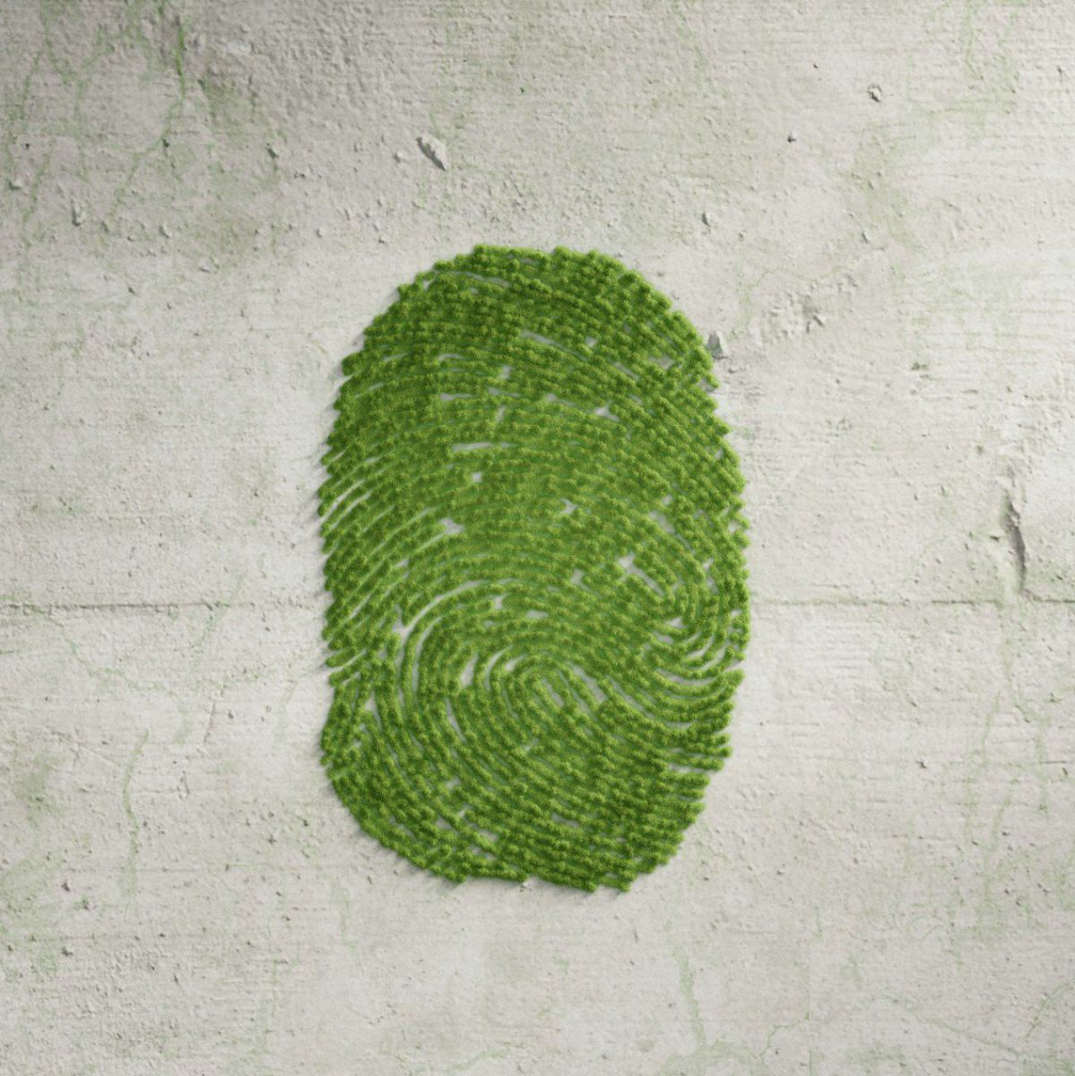 ein grüner Fingerabdruck auf einer grauen Betonwand.